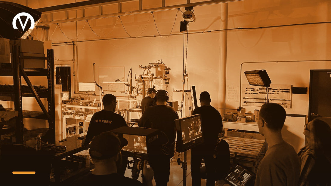 Venture Creations film crew on location with camera monitors and lighting, shooting video inside a manufacturing facility.